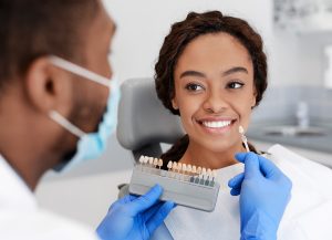 dentist color-matching patient's teeth