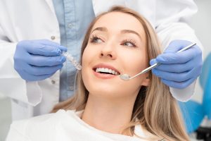 woman in dental chair getting dental exam