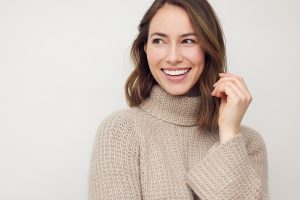 woman smiling and looking off to side