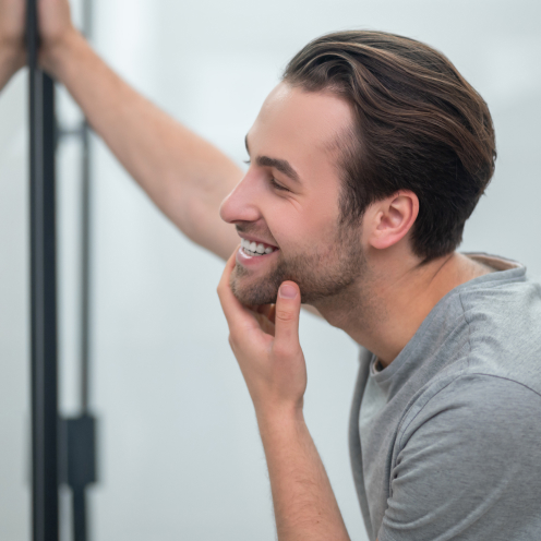 man smiling in mirror