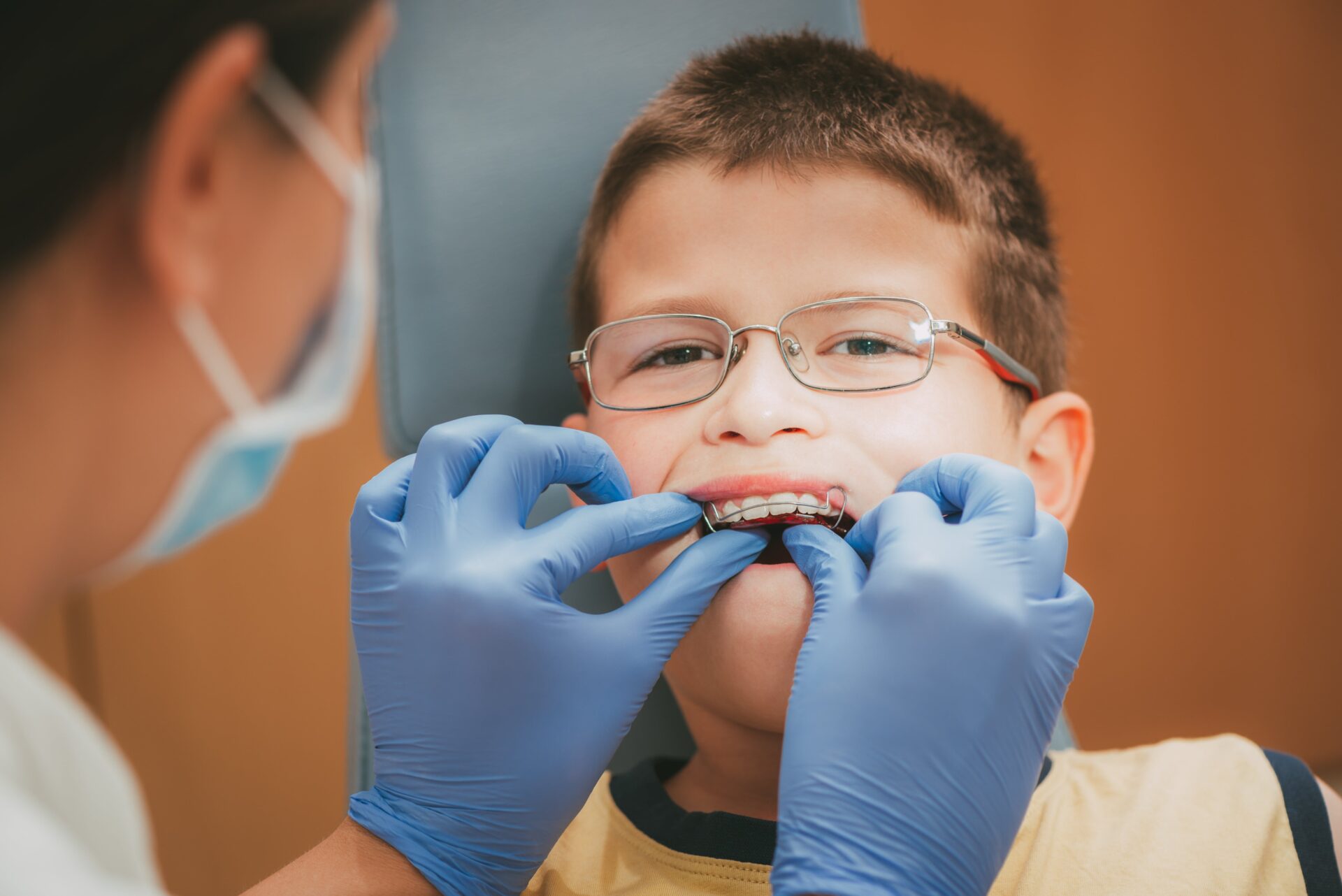 Dentist examining child's braces and teeth in Knoxville, TN